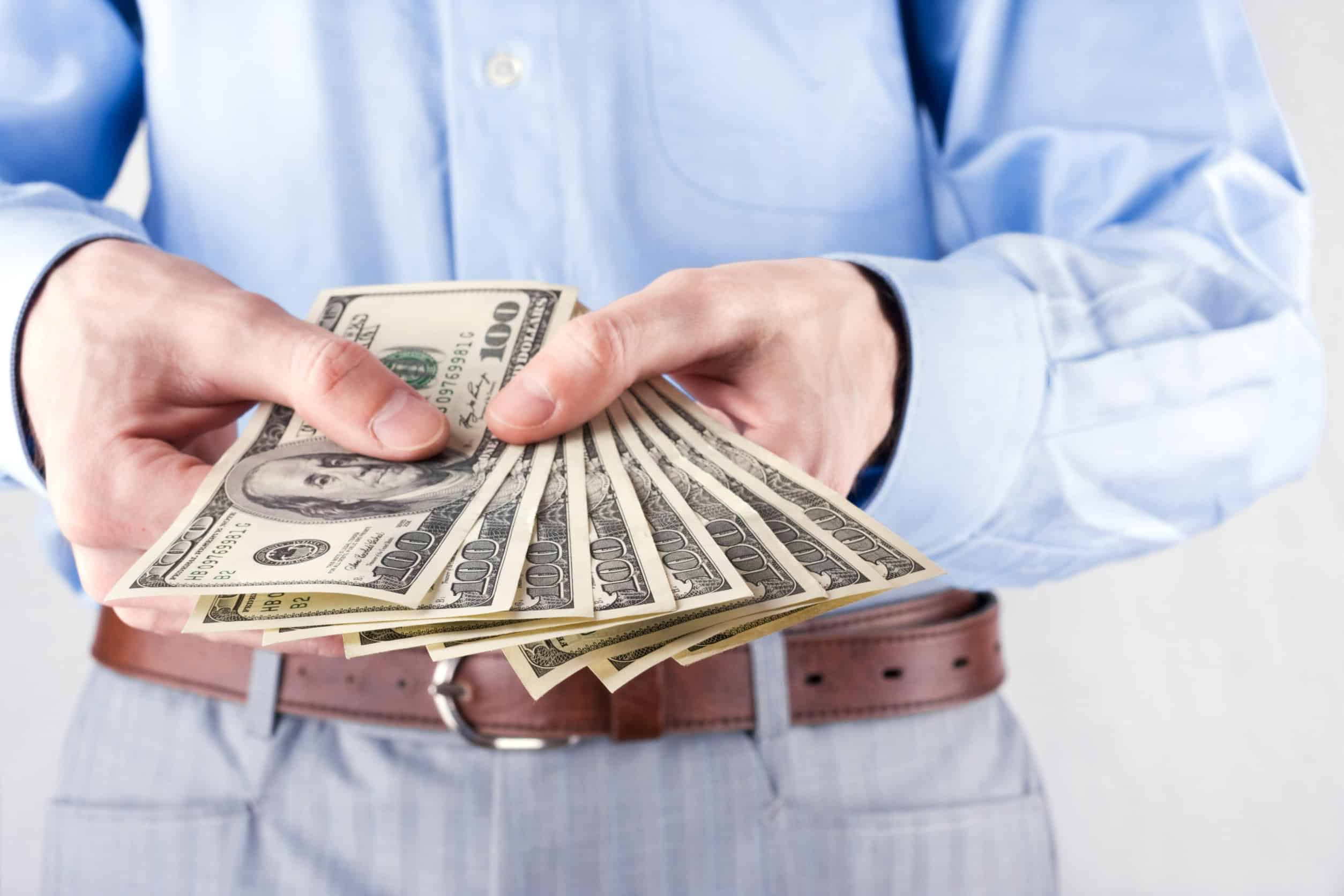 Man holding money US currency